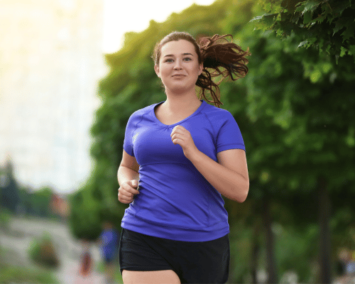 A woman wearing a blue shirt and jogging